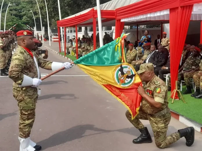 le général de brigade Serge Oboa baisant l’étendard